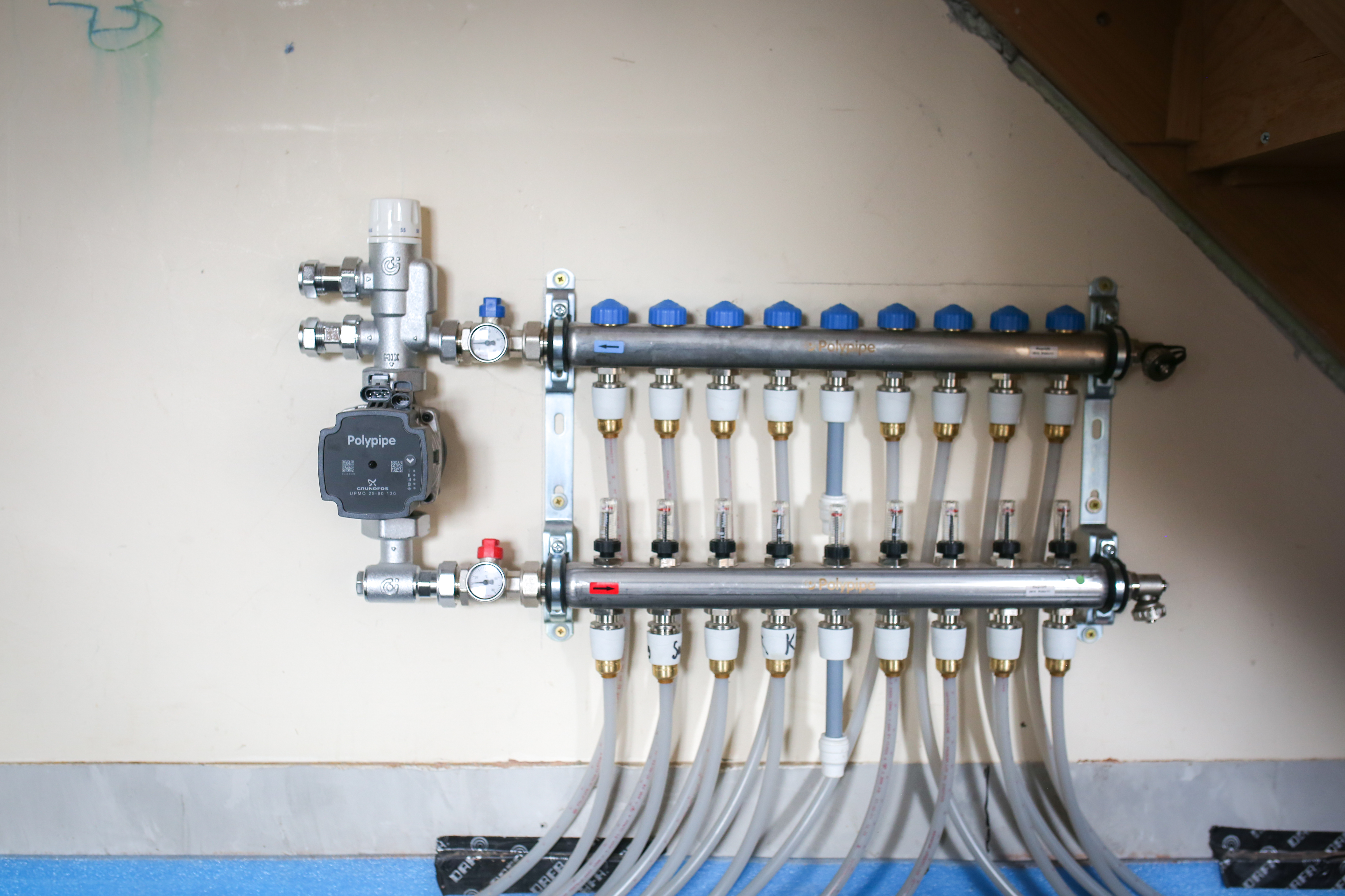 Polypipe's Auto-balancing Underfloor Heating Manifold mounted on a wall.
