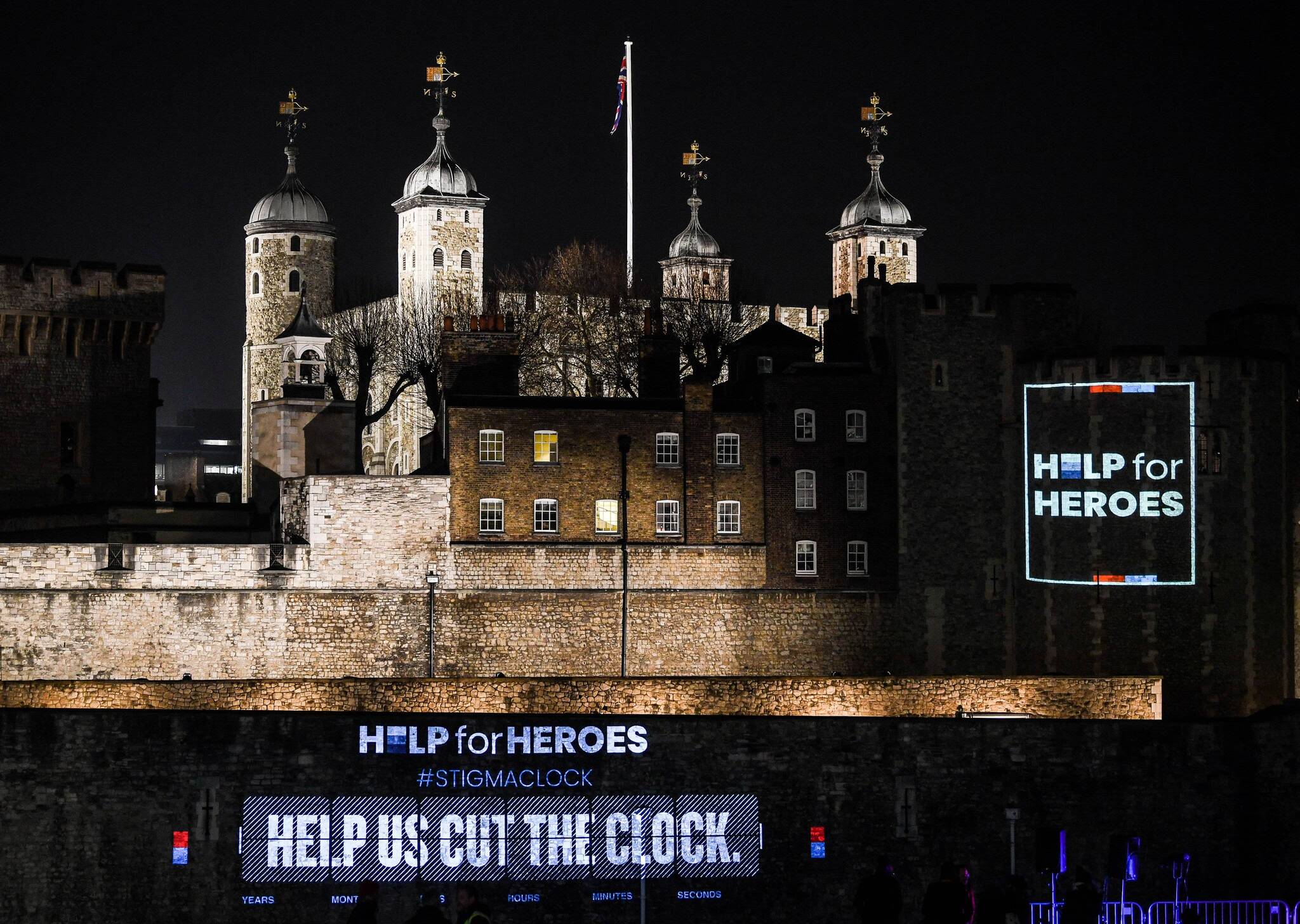 Help For Heroes 'Cut the Clock' logo is projected onto the Tower of London