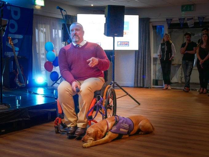 Help for Heroes Beneficiary Jon Giemza-Pipe speaks at the Polypipe regatta. Next to him is his service dog.