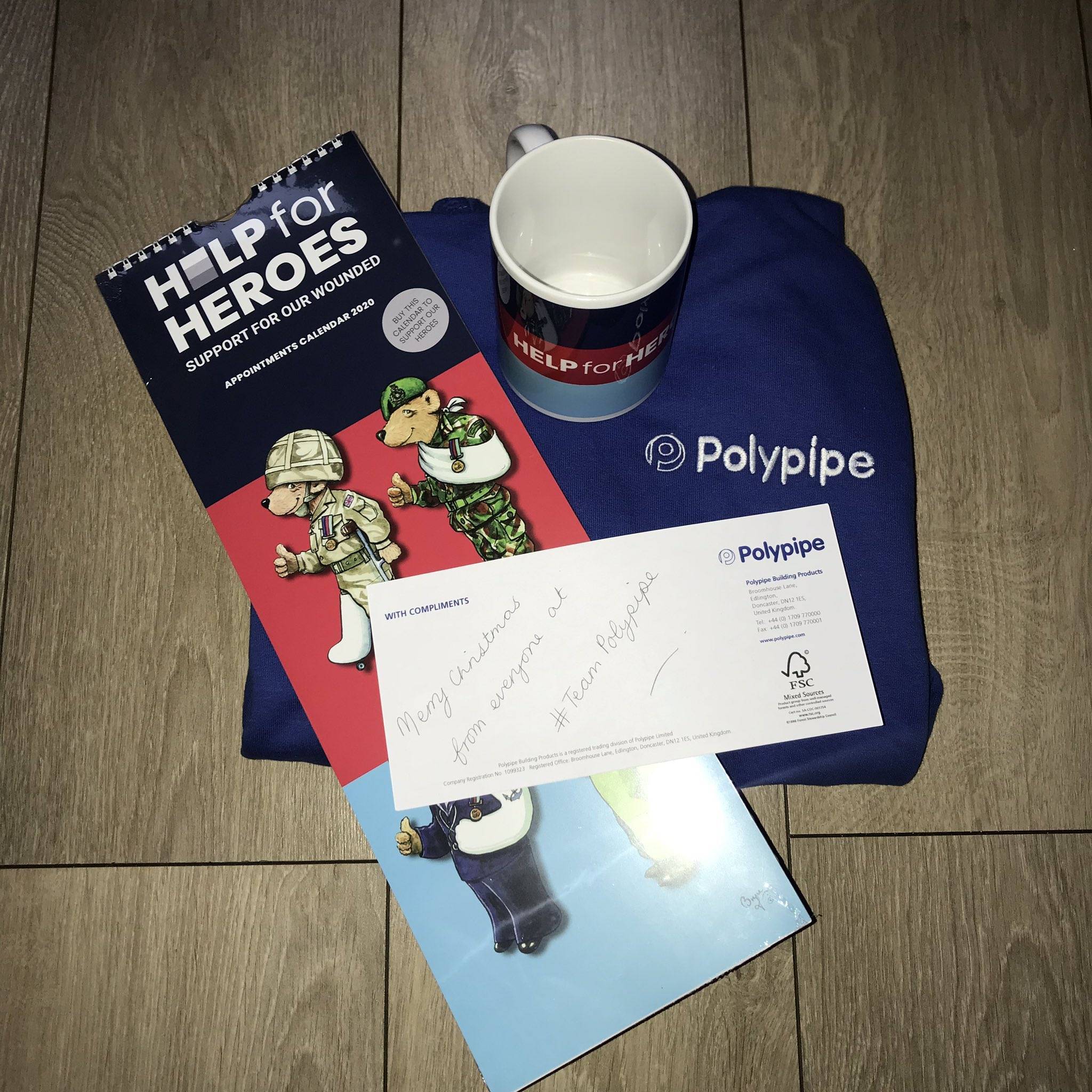 Help for Heroes Mug and Calendar with a Polypipe calendar and note saying 'Merry Christmas from everyone at #TeamPolypipe'
